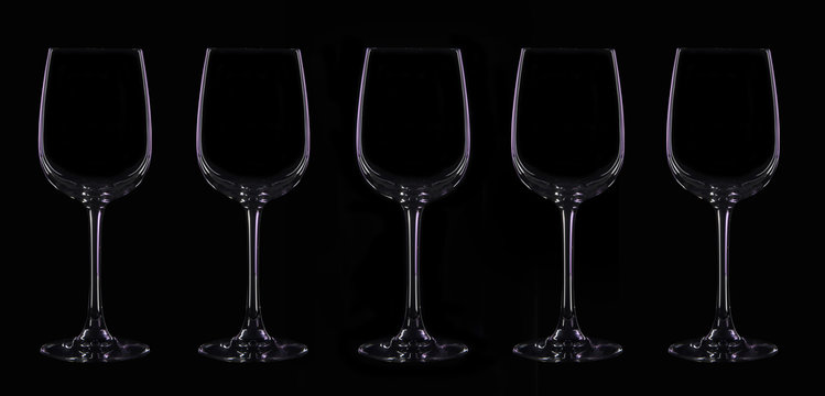 Silhouette of wineglass with violet illumination