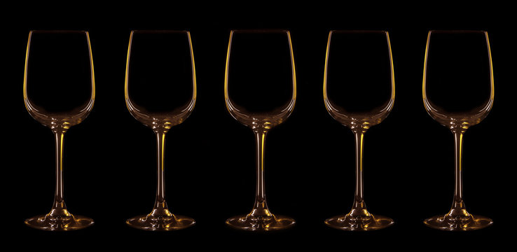 Silhouette of wineglass with yellow and brown illumination