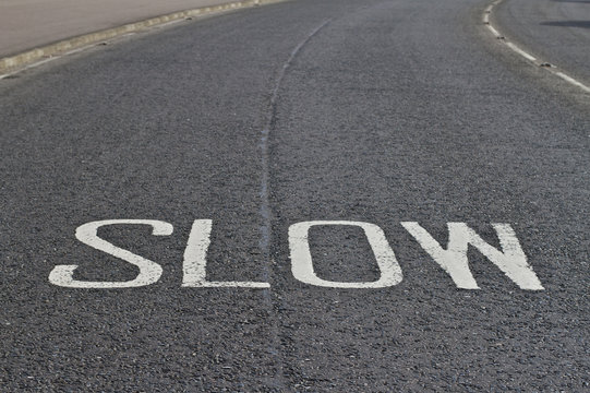 Road marking slow text on road