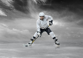 Ice hockey player in action outdoor around mountains