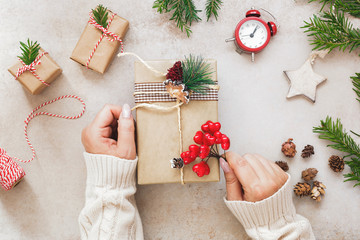 Christmas gift preparations. Woman wraps gifts for the holidays, top view, flat lay