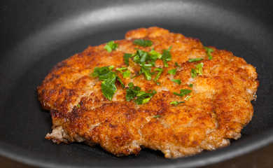 big and juicy meat burger cutlet on iron pan