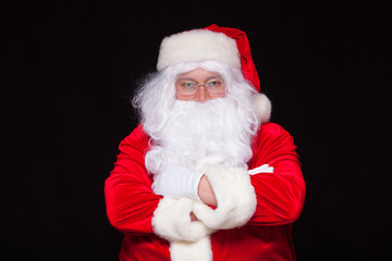 Fototapeta na wymiar Christmas. Santa Claus portrait smiling against black background.