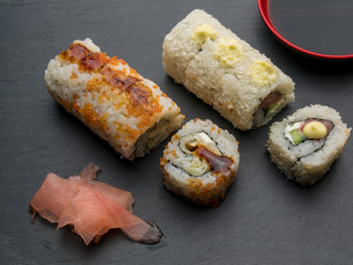 Japanese Sushi - Kappa Maki Sushi Roll  with Soy Sauce and Ginger over Stone Background. Top View.