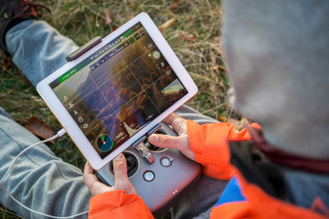 Man operating a drone using a remote controller