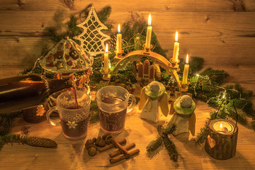 Fototapeta na wymiar Traditional mulled wine in glasses. Christmas decoration and ornaments on wood background. Festive Christmas alcoholic drink in an atmospheric environment