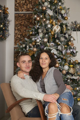 Young couple on a christmas tree background