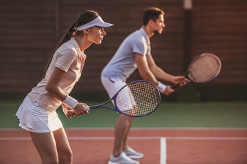 Couple playing tennis
