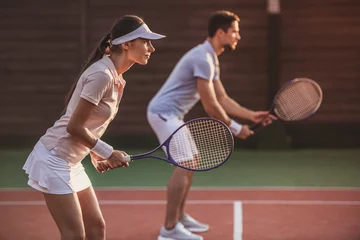 Rolgordijnen Couple playing tennis © georgerudy