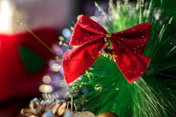 Red christmas bow on the green christmas tree