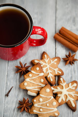 Red cup of tea and Christmas cookies on the grey wooden  table