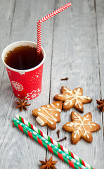 Red cup of tea and Christmas cookies on the grey wooden  table
