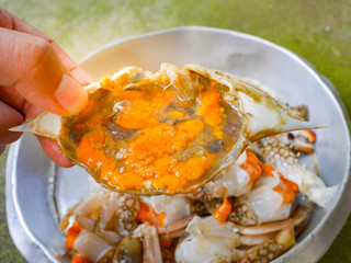 crab for cooking with hand , hot and spicy fried crab