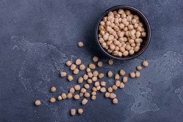 Chickpeas in bowl on dark background