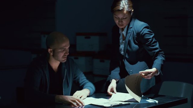  Female detective questioning crime suspect or witness at police station
