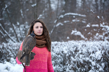 Fototapeta na wymiar Woman is walking with a falcon