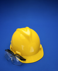 Fototapeta premium Yellow Hard Hat on Blue back drop