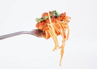 Spaghetti bolognese on a fork on a white background