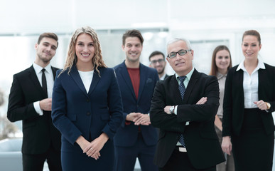 businessman and business woman standing in front of the business team.