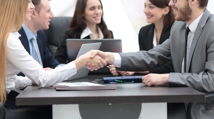 Fototapeta na wymiar handshake between a businesswoman and a businessman