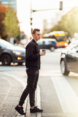 Fototapeta premium Man walk on the street with cup of coffee