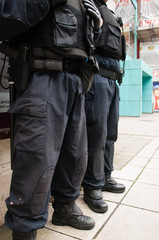 Two armed police officers stand guard on British streets.