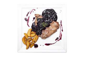 steak entrecote on pork bone with blueberry sauce. meat with berry sauce. delicious recipe. berry sauce