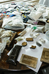 Fototapeta premium Blocks/bricks of cannabis resin on display by police with herbal cannabis, and other drugs including so-called 