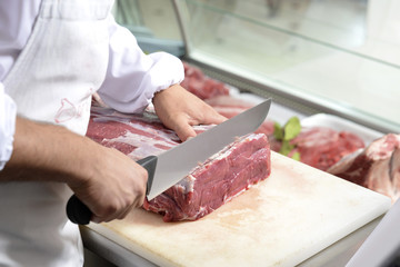 butcher cuts a steak