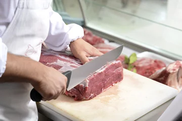 Foto auf Acrylglas butcher cuts a steak © easyasaofficial