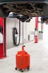 Draining the Oil of a Car in an Oil Drain Tank