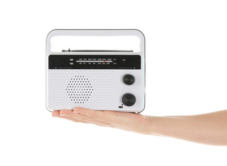 Woman holding radio on white background