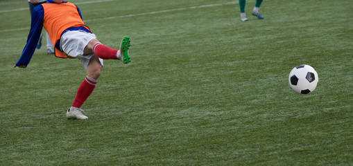  Young Soccer Players Running After the Ball.