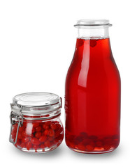 Fototapeta na wymiar Bottle of goji juice and jar with berries on white background