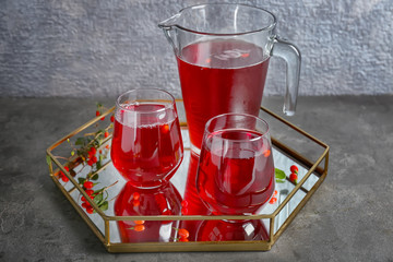 Glasses and jug with goji juice on tray