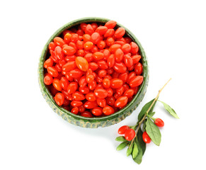 Bowl with goji berries on white background