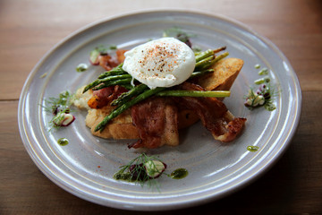 eggs benedict poached egg on bacon asparagus and bread breakfast