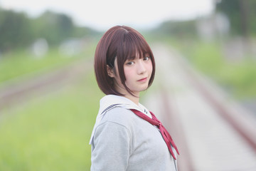 Portrait of Japanese school girl with countryside park