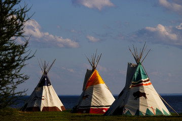 Bunch of teepee forgotten on an empty lot by the ocean in Maria, Quebec