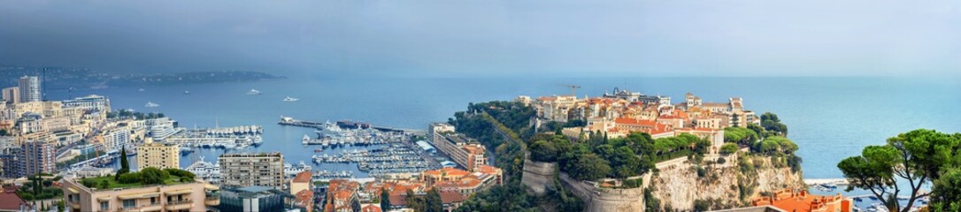 Panoramic view of Monaco coast at sunset in overcast day