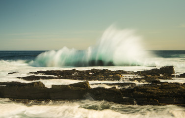 Waves breaking on shore