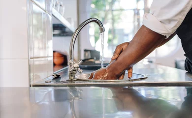 Küchenrückwand glas motiv Chef washing his hands in commercial kitchen © Jacob Lund