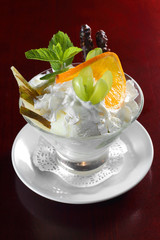Ice cream in a glass cube with fruits
