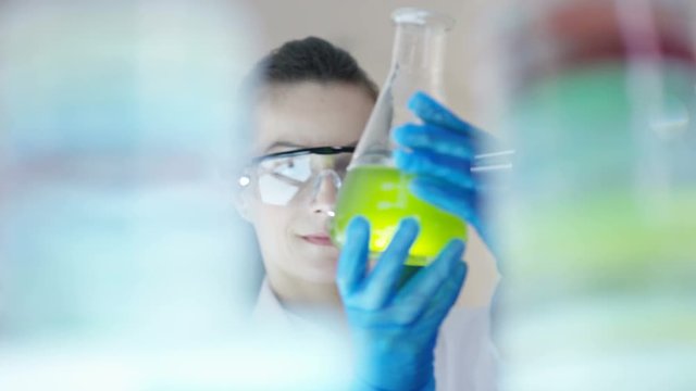 Close up portrait smiling chemical research scientist working in the lab.