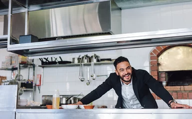 Foto op Plexiglas Smiling restaurant owner standing at kitchen counter © Jacob Lund