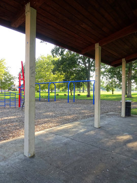 An open shelter house in a tiny kids play area.