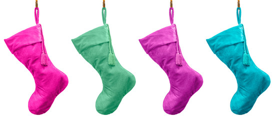 Plush Pastel velvet Christmas stockings hanging from brass hooks