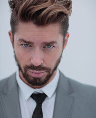 Close up portrait of a smiling handsome business man  over white