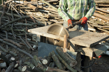 Builder Using Saw to Cut Wood in the village