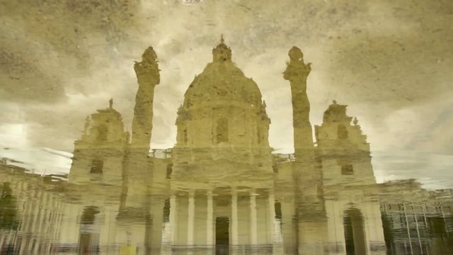 Karlskirche church reflecting in the fountain water at Karlsplatz square Vienna Austria